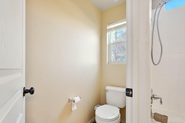 bathroom with shower / bath combination and toilet