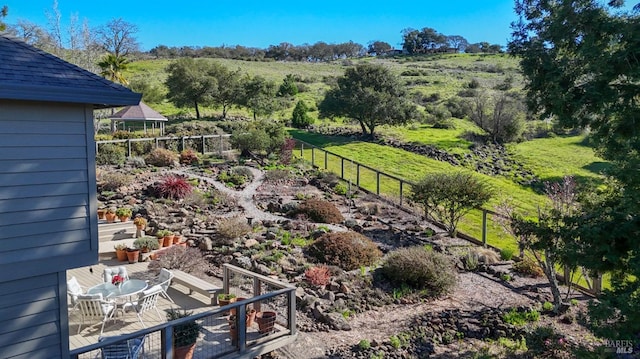 view of yard with outdoor dining area and fence