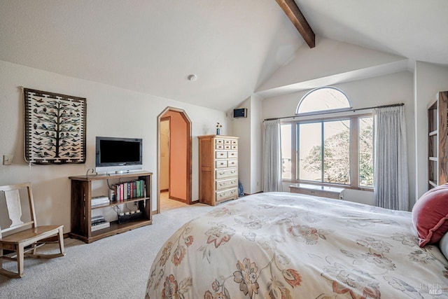 bedroom featuring vaulted ceiling with beams, carpet floors, and arched walkways