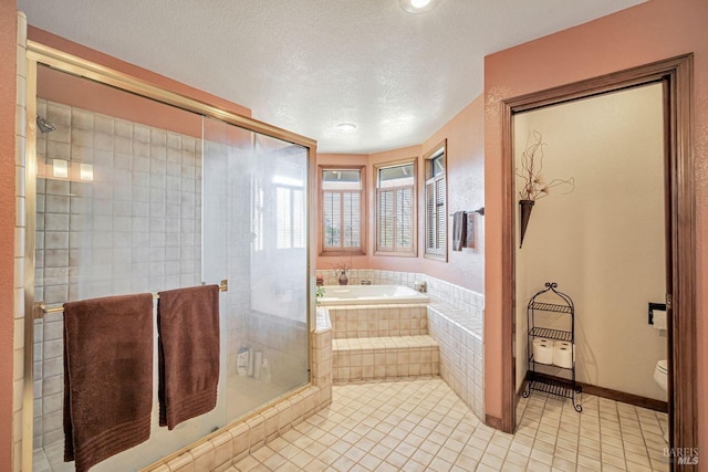 bathroom featuring a textured ceiling, toilet, a bath, tile patterned floors, and a stall shower