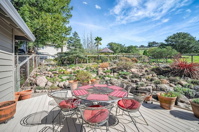 wooden terrace with outdoor dining space