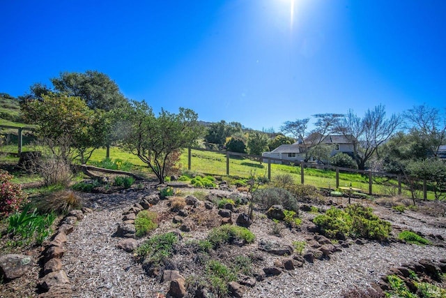 view of yard featuring a rural view and fence