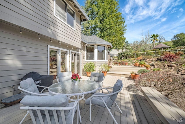 wooden deck with fence and outdoor dining space