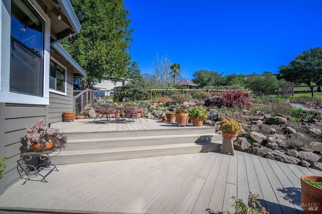 wooden terrace featuring outdoor dining area