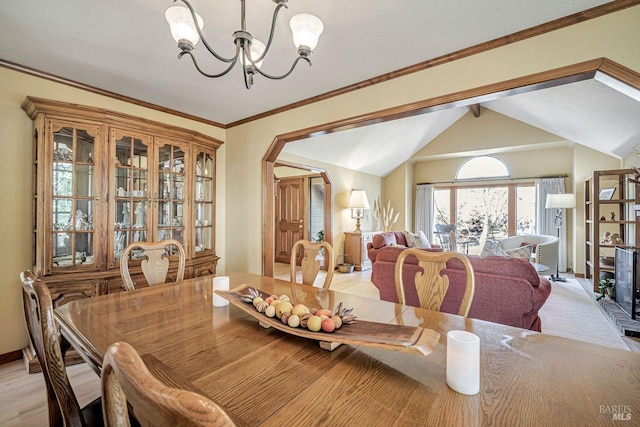 dining area with lofted ceiling with beams, arched walkways, baseboards, ornamental molding, and an inviting chandelier