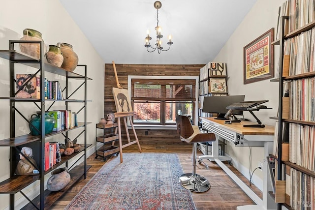 home office with a chandelier, wooden walls, and wood finished floors