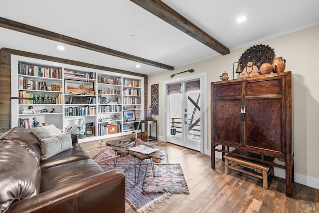 living room featuring french doors, beamed ceiling, hardwood / wood-style floors, and baseboards