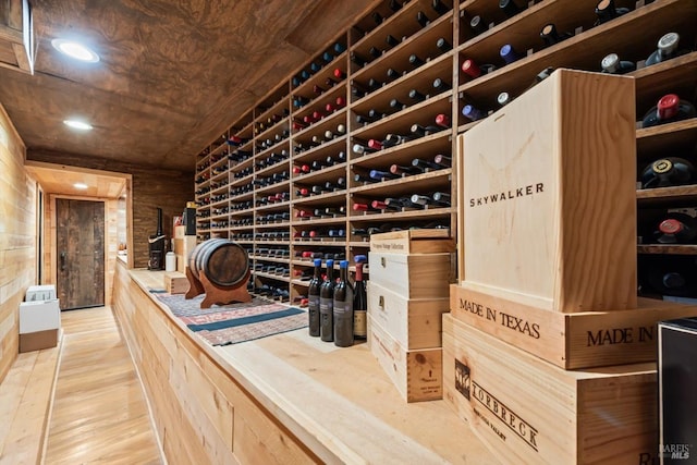 wine room with wooden walls and wood finished floors