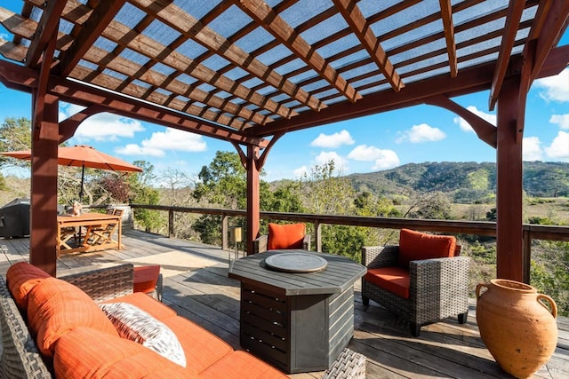 deck featuring outdoor dining space, outdoor lounge area, and a pergola