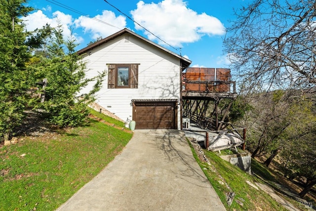 exterior space featuring driveway and a yard