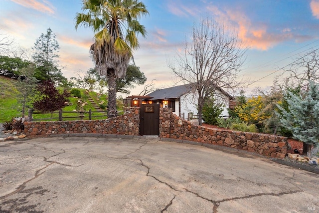 exterior space featuring a fenced front yard and a gate