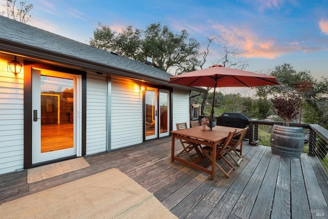 deck with outdoor dining space and grilling area