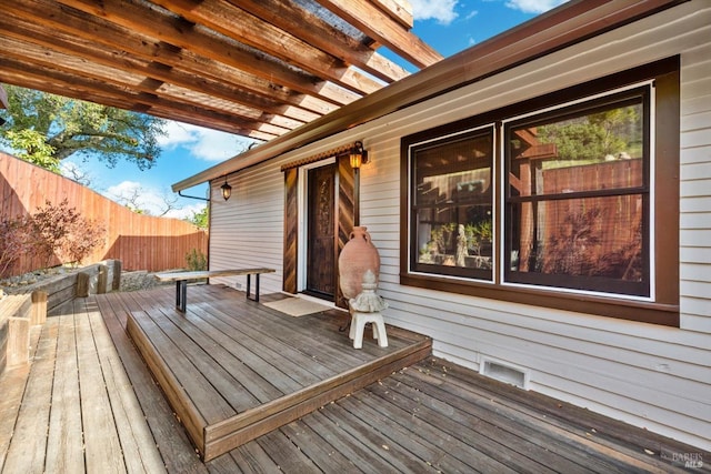 wooden terrace featuring visible vents, fence, and a pergola