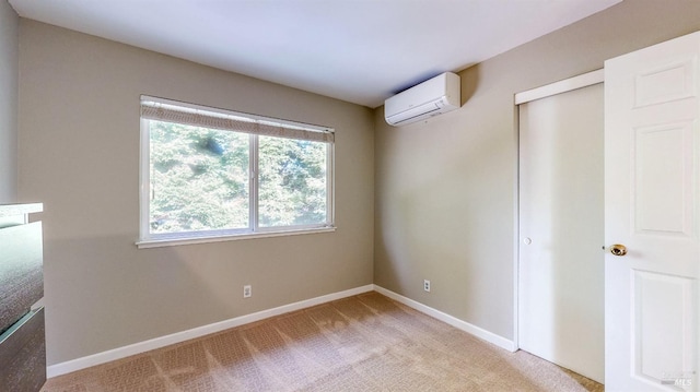 unfurnished bedroom featuring baseboards, a closet, a wall mounted air conditioner, and light colored carpet