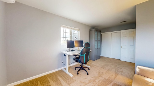 office featuring light carpet, visible vents, and baseboards