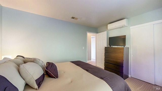 bedroom featuring a closet, visible vents, carpet flooring, and a wall mounted AC