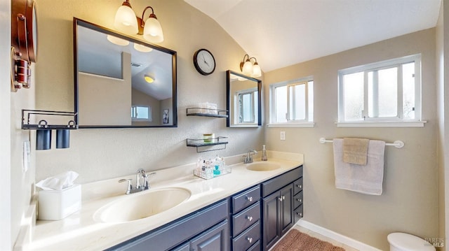 full bathroom with a wealth of natural light, a sink, lofted ceiling, and double vanity