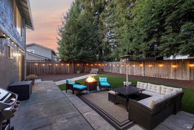 view of patio featuring a fenced backyard, grilling area, and an outdoor living space with a fire pit