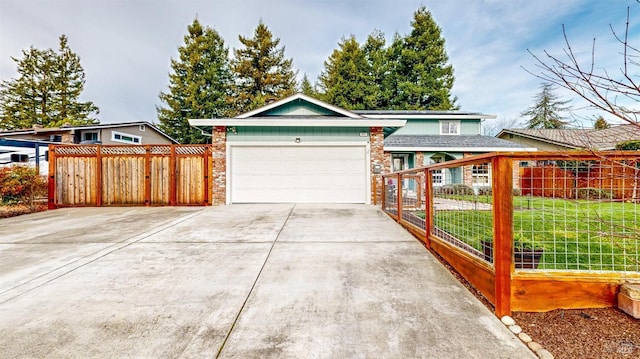 view of front of property featuring a garage, a front yard, concrete driveway, and fence