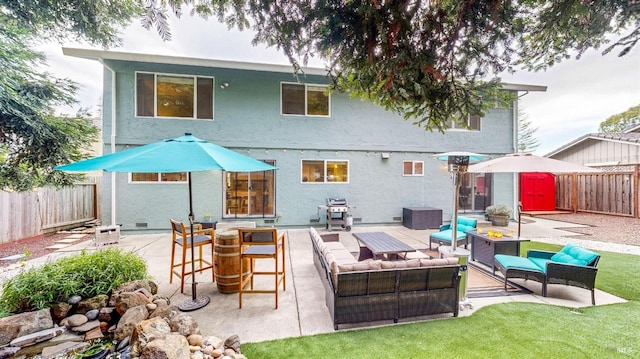 back of house featuring stucco siding, a fenced backyard, a patio, and an outdoor hangout area