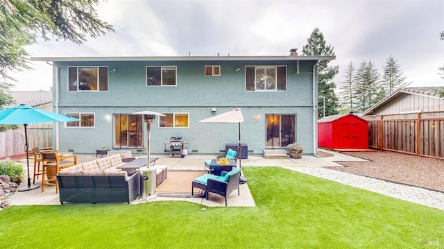 rear view of property with outdoor lounge area, an outdoor structure, a fenced backyard, and a shed