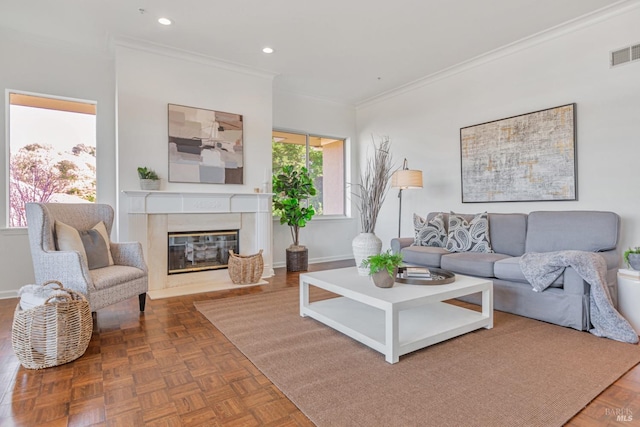 living area with crown molding, a fireplace, recessed lighting, visible vents, and baseboards