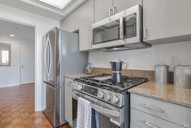 kitchen with appliances with stainless steel finishes and light stone counters