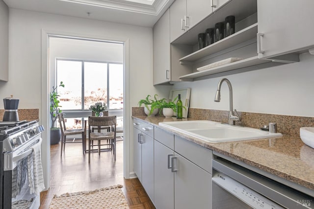 kitchen featuring a sink, white cabinets, appliances with stainless steel finishes, light stone countertops, and open shelves