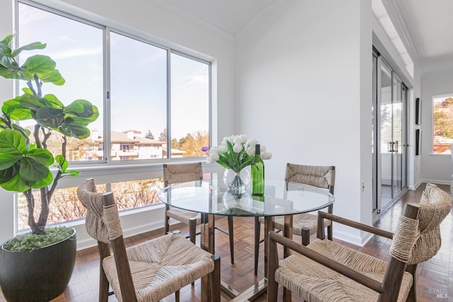 dining room with baseboards and ornamental molding