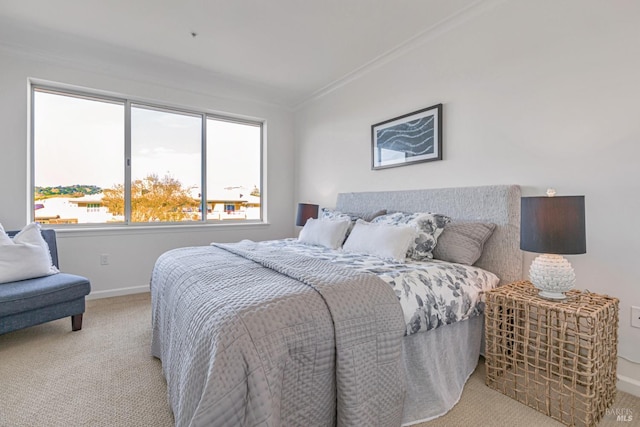 bedroom featuring baseboards, ornamental molding, and light colored carpet