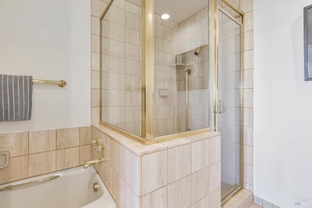 full bath featuring a stall shower and a bath