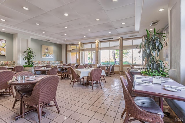 dining space featuring recessed lighting, visible vents, a raised ceiling, and light tile patterned flooring