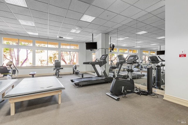 workout area with a drop ceiling and baseboards