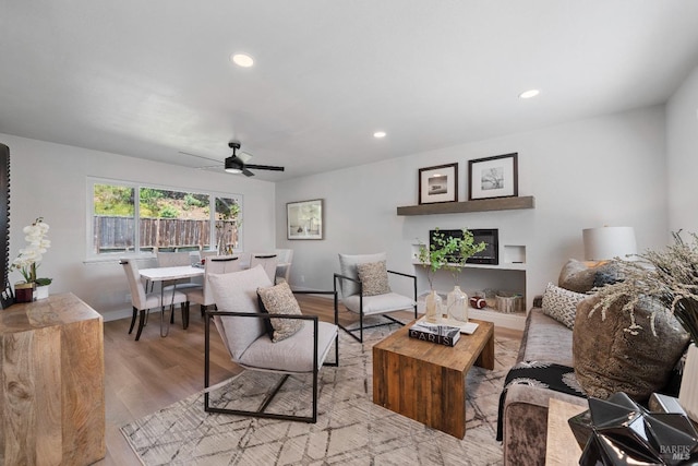 living room with recessed lighting, a ceiling fan, wood finished floors, and baseboards