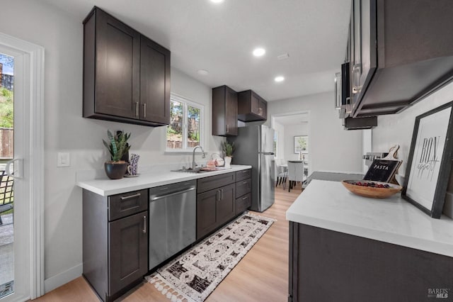 483 Rinconada Ct, Benicia, CA 94510 - kitchen featuring stainless steel appliances, light wood-style floors, a sink, light countertops, and recessed lighting