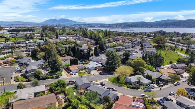 bird's eye view with a water and mountain view and a residential view