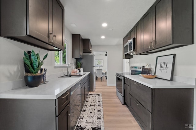 483 Rinconada Ct, Benicia, CA 94510 - kitchen with appliances with stainless steel finishes, a sink, light countertops, light wood-type flooring, and recessed lighting