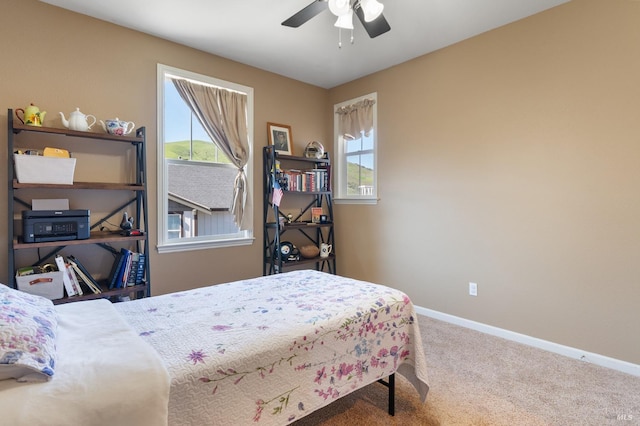 bedroom with carpet floors, ceiling fan, and baseboards