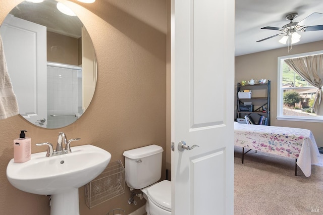 ensuite bathroom with a shower, toilet, a ceiling fan, a sink, and connected bathroom