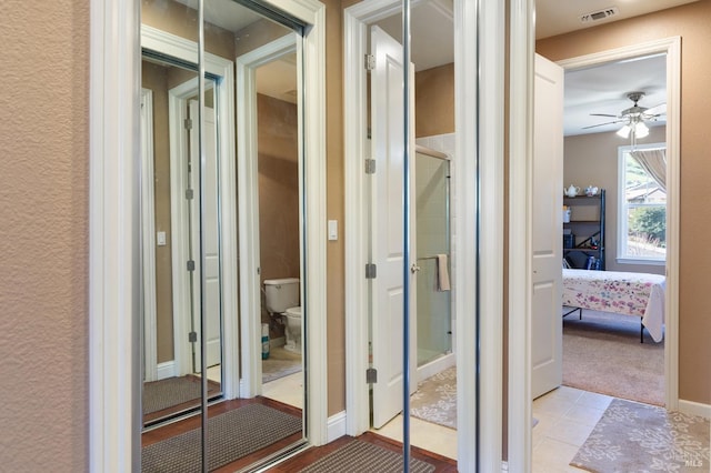 bathroom featuring a stall shower, visible vents, toilet, ensuite bath, and tile patterned floors