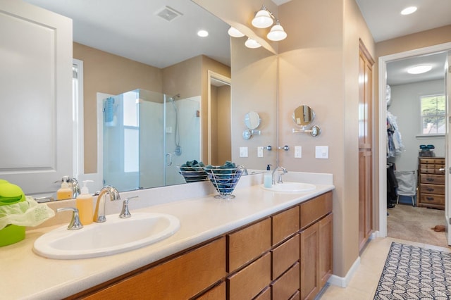 full bathroom with double vanity, visible vents, a sink, and recessed lighting