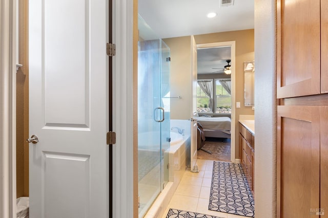 bathroom with a stall shower, ensuite bath, tile patterned floors, vanity, and a bath