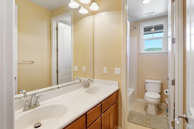 bathroom with shower / bathtub combination, double vanity, a sink, and toilet