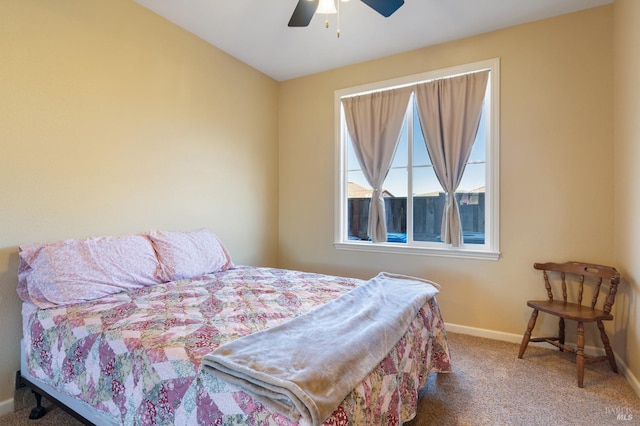 carpeted bedroom featuring ceiling fan and baseboards