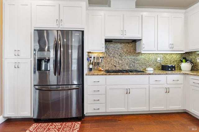 kitchen with range hood, stone countertops, white cabinetry, and stainless steel fridge with ice dispenser