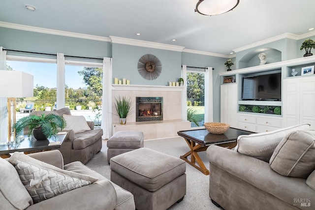 living area featuring ornamental molding, recessed lighting, carpet floors, and a tiled fireplace