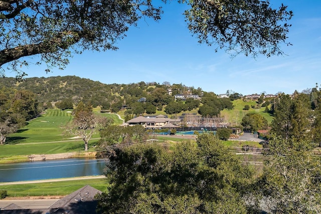 birds eye view of property featuring view of golf course and a water view