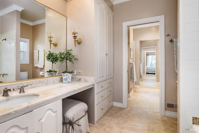 bathroom with baseboards, visible vents, toilet, crown molding, and vanity