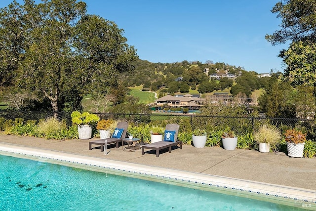 view of pool with fence, a fenced in pool, and a patio