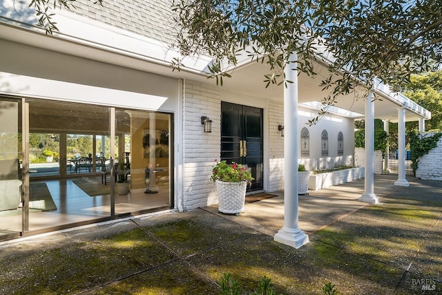 exterior space with a patio area and brick siding